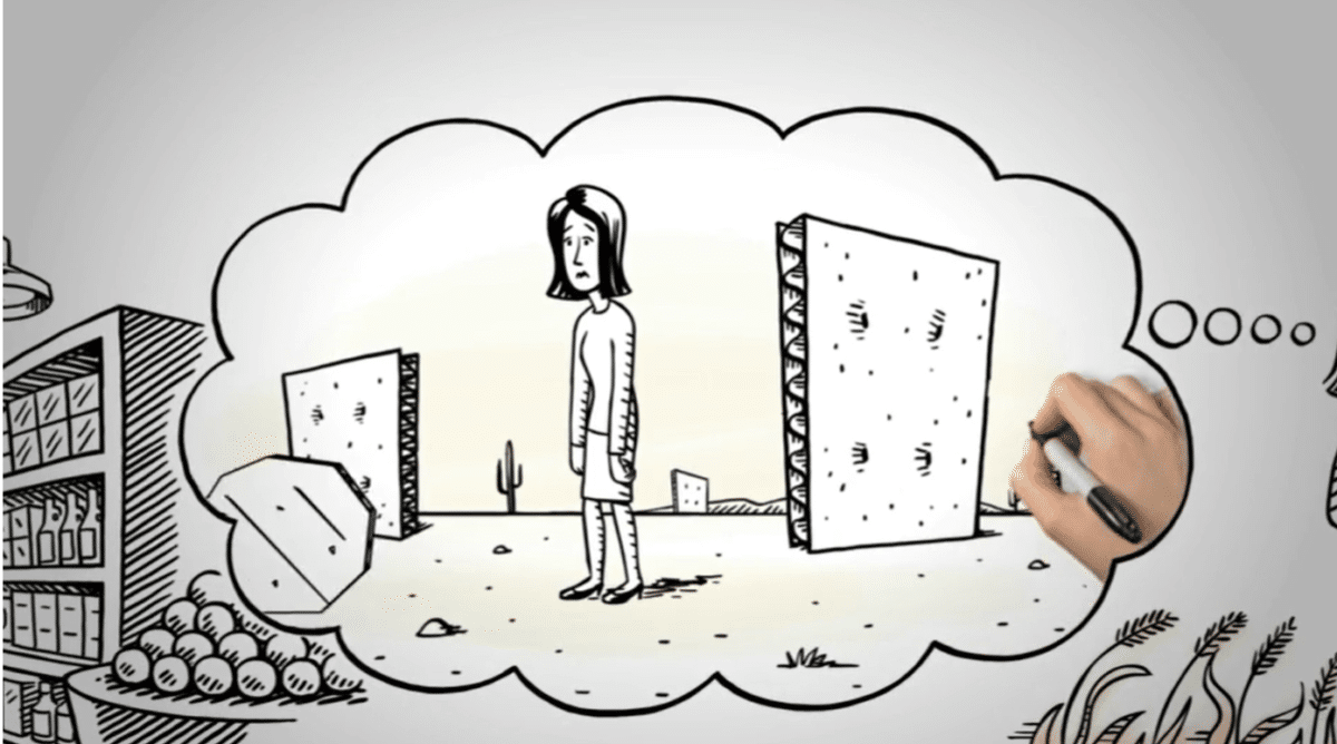 A hand draws a cartoon of a sad woman standing between two large walls in a desert, store shelves of produce on the left. In this whiteboard video, color highlights her feelings of isolation inside a thought bubble.