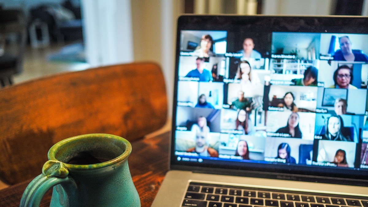 virtual meeting on laptop with a mug