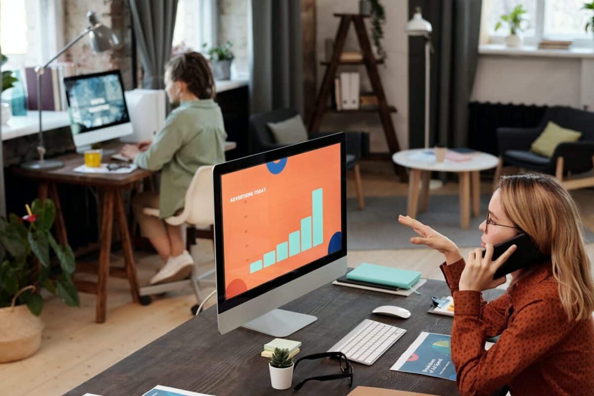 Marketer looking at a data screen while on the phone with a client
