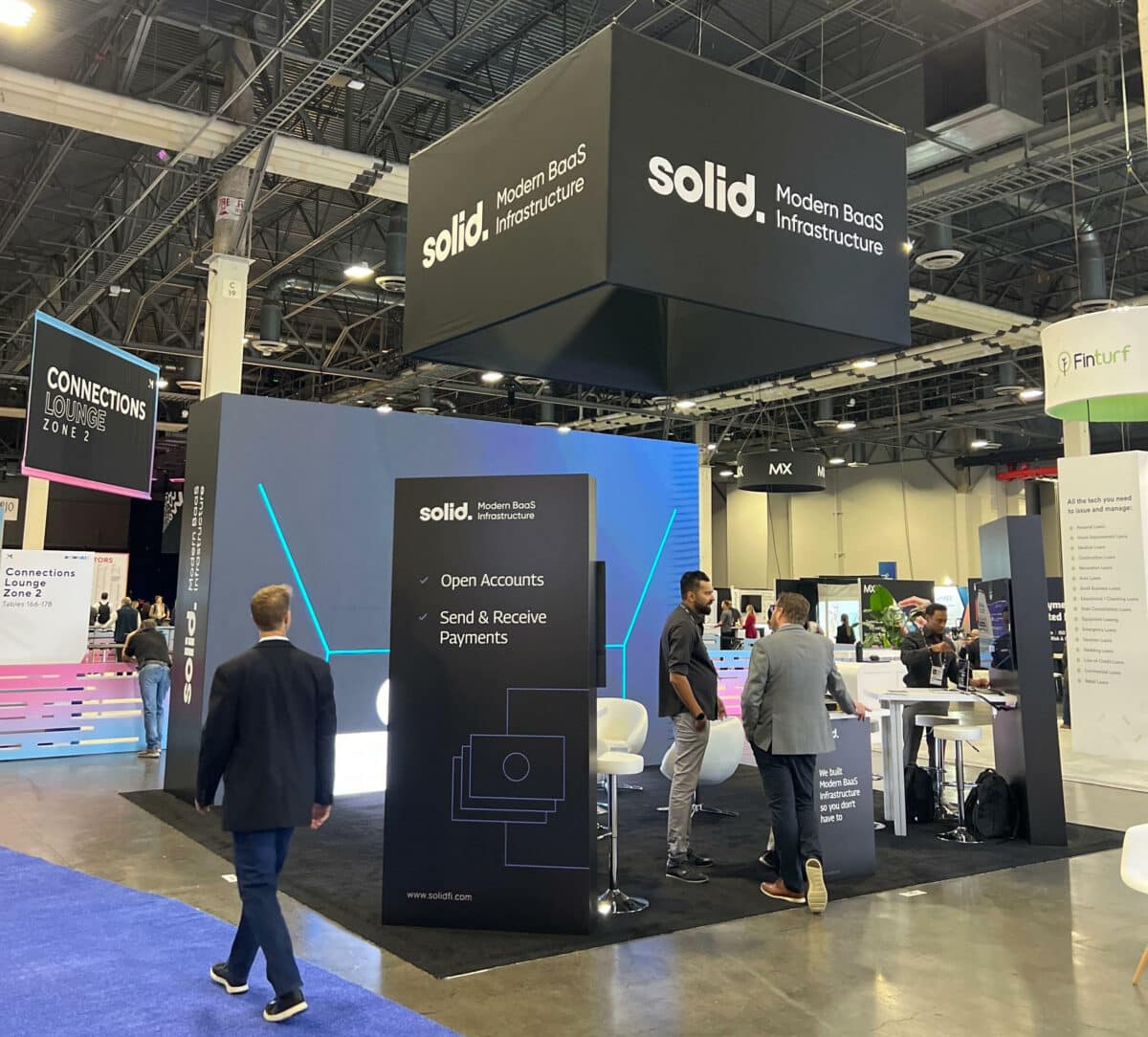 Solid's display featuring a trade show video on the entire back wall of their space