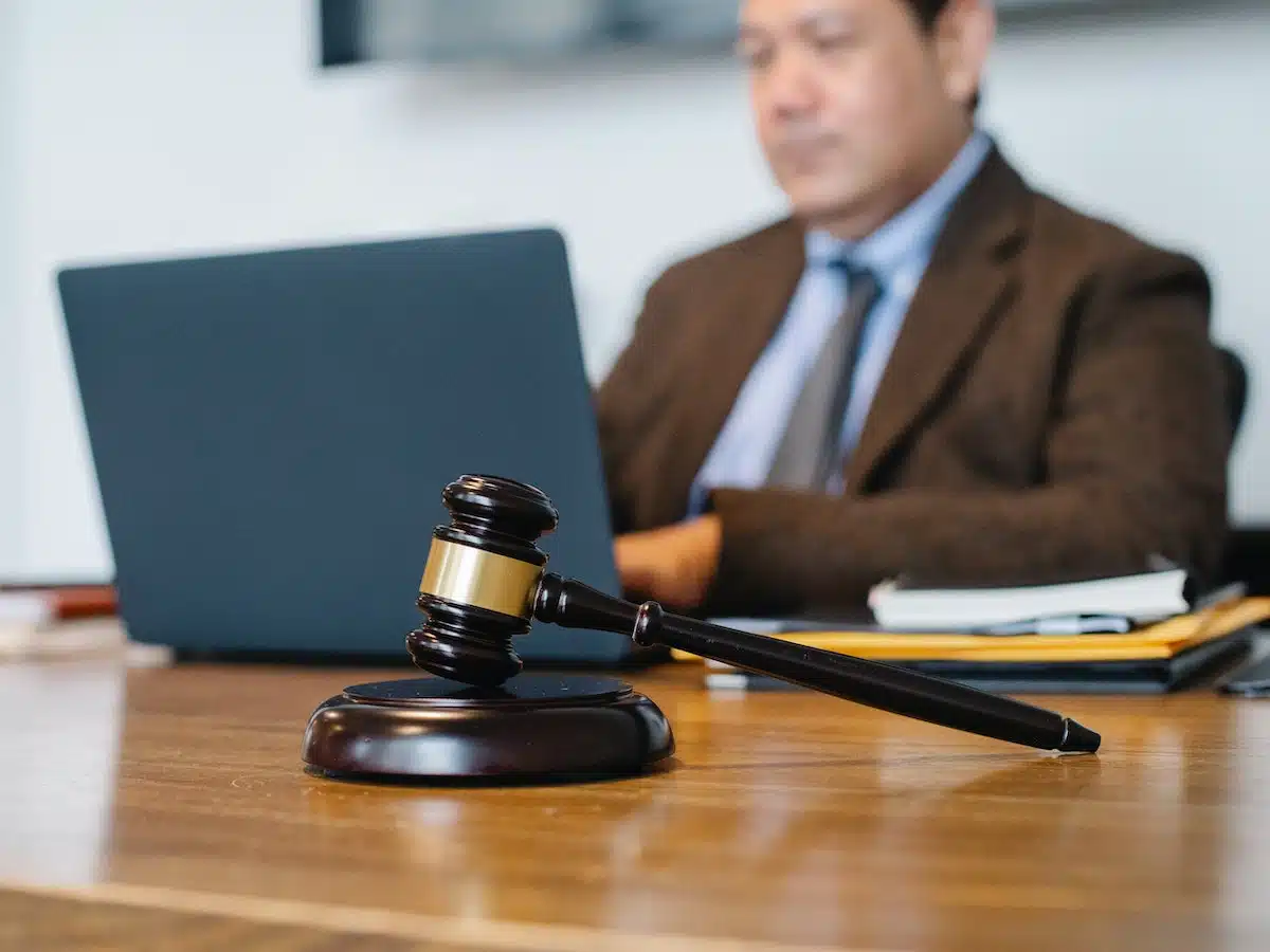 judge sitting behind a laptop watching a legal animation
