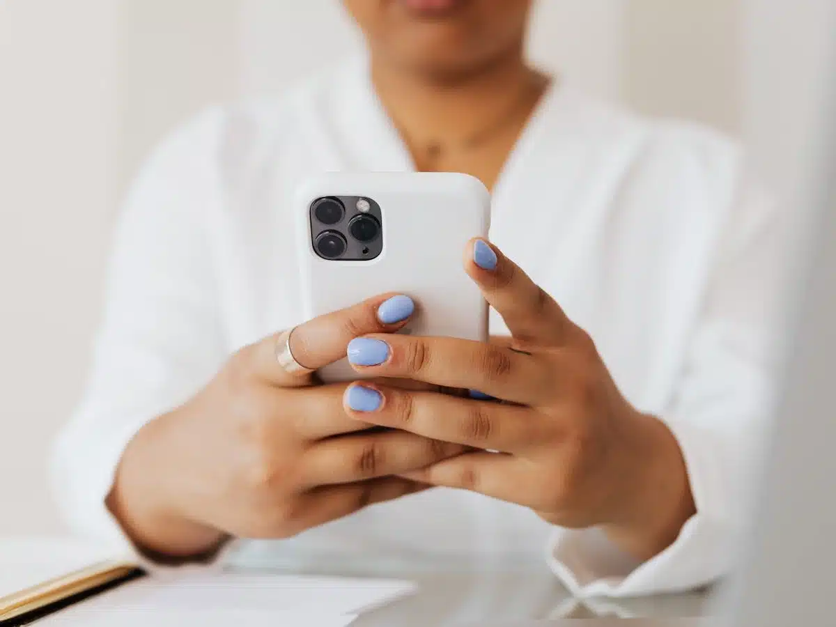 hands holding a cell phone vertically to watch a mobile video